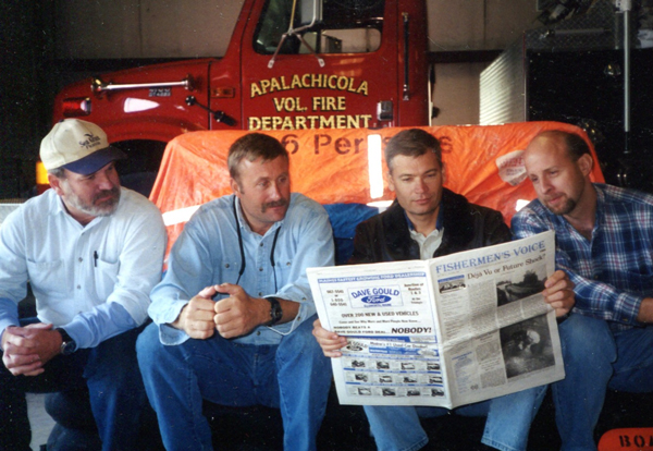 USCG Men Reading Fishermen's Voice
