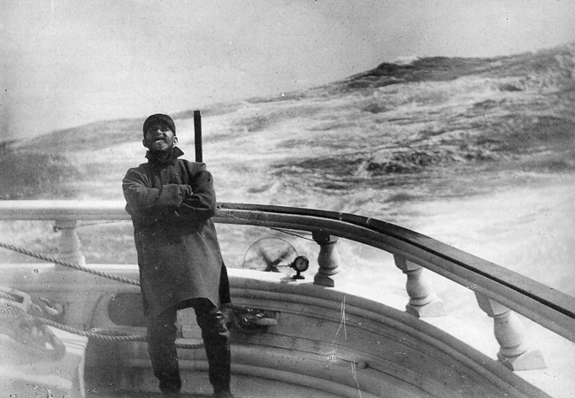 Man standing on deck of ship.